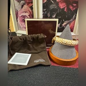 Coach signature C white enamel and gold tone hinged bracelet